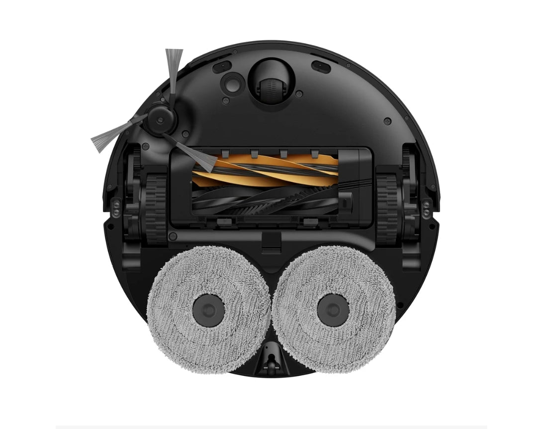 Top-down view of a round robotic vacuum cleaner showing the underside with two gray floor mops, a black chassis, and a brush bar with orange and black bristles, isolated on a white background.