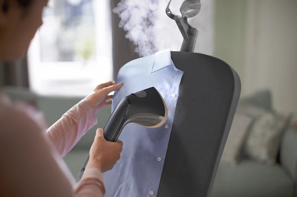 Philips Stand Steamer 3000 Series with Tilting StyleBoard, shown in a home setting, featuring the steamer and adjustable board.