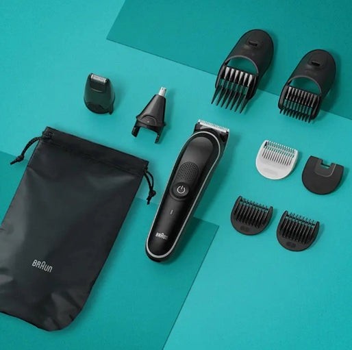 Braun Multi Grooming Kit MGK5440 with various attachments, including beard trimmer, nose/ear trimmer, and combs. Black and grey design.