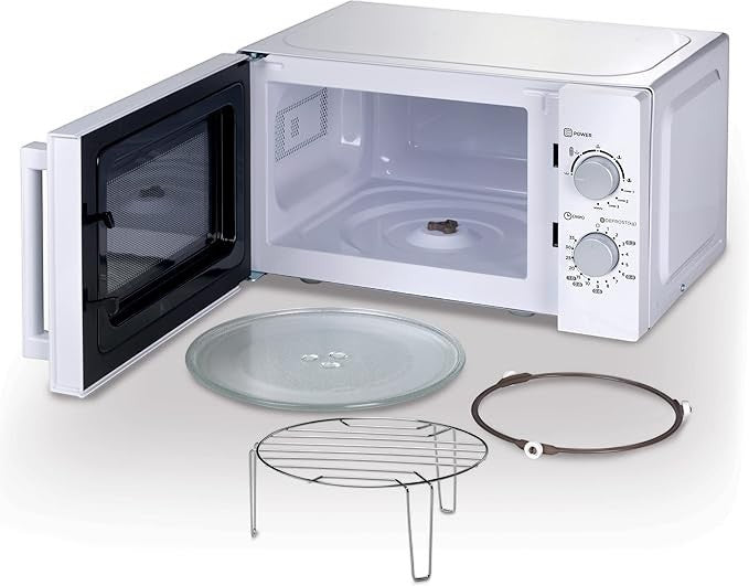 Taghareed Kenwood 20L white microwave oven with open door, glass turntable, and wire rack. Features mechanical controls and defrost function.