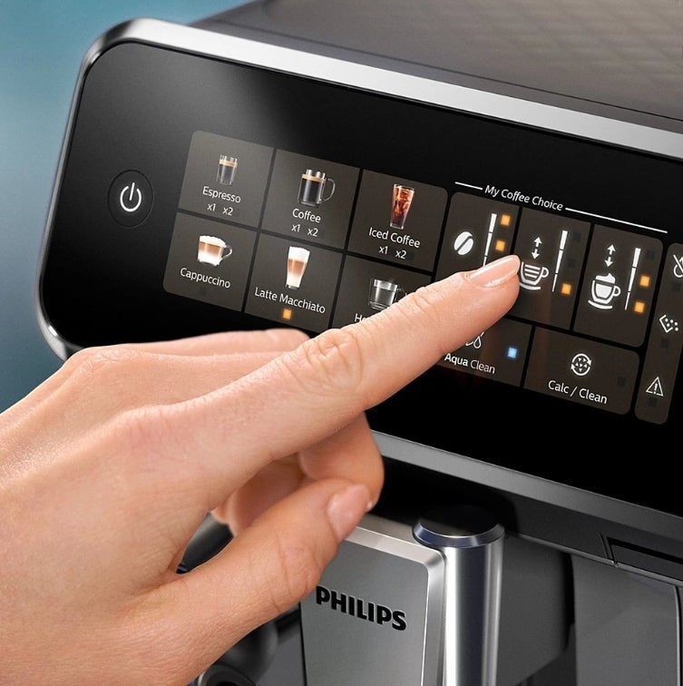 Taghareed Philips 3300 Series espresso machine touch screen with coffee options like Espresso, Coffee, Iced Coffee, Cappuccino, Latte Macchiato.