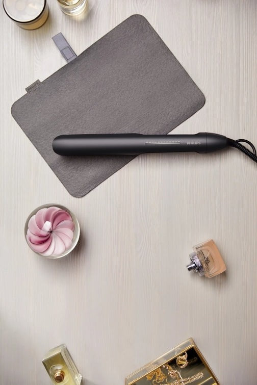 Taghareed Philips 5000 Series black hair straightener with argan-oil infused plates and ThermoShield technology.