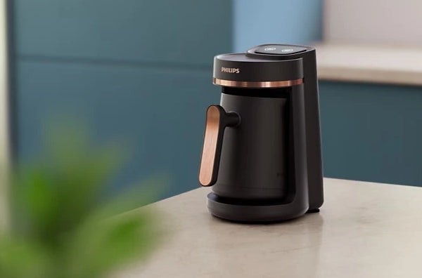 Taghareed Philips 5000 Series black Turkish coffee maker with rose gold accents, slow brew, and anti-overflow.