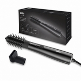 Braun hair styling brush with a round brush attachment and a nozzle attachment, shown in front of its black retail box on a white background.