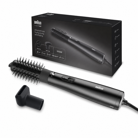 Braun hair styling brush with a round brush attachment and a nozzle attachment, shown in front of its black retail box on a white background.