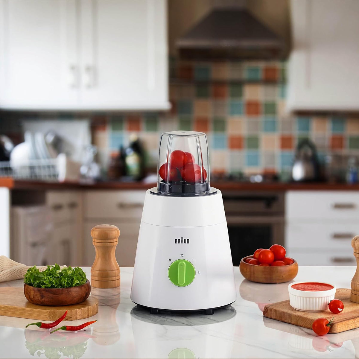 Braun blender on a kitchen counter with ingredients around