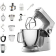 Kitchen stand mixer with various attachments on a white background