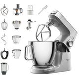 Kitchen stand mixer with various attachments on a white background