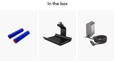 In the box section showing included accessories on a light gray background: two blue cylindrical sleeves with a small red end, a black mounting stand, and a gray power adapter with a coiled cable.