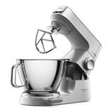 Silver stand mixer with a clear mixing bowl on a white background