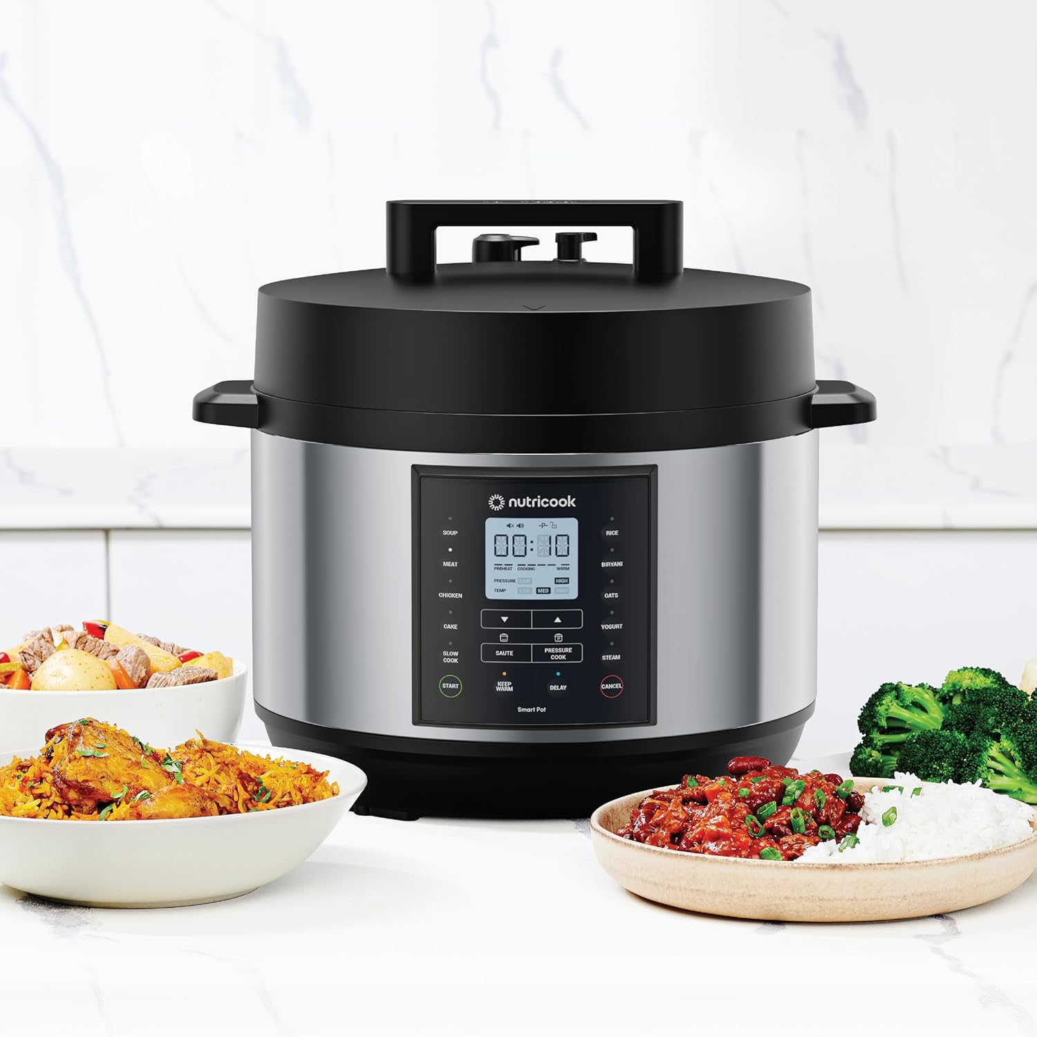 NutriCook pressure cooker with plates of food on a white background