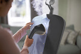 Philips Stand Steamer 3000 Series with Tilting StyleBoard, shown in a home setting, featuring the steamer and adjustable board.