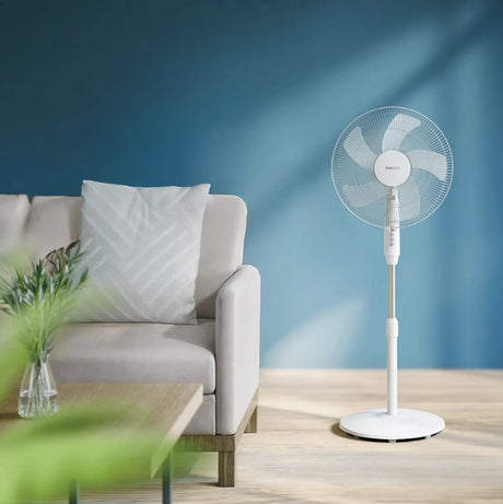 Philips Series 600 pedestal fan with adjustable height and blades, shown in a home setting.