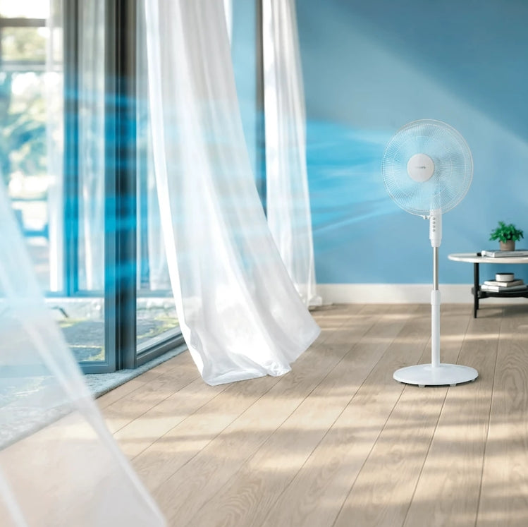 Philips Series 600 pedestal fan with adjustable height and blades, shown in a home setting.