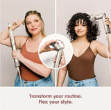 Two women demonstrate a silver and white hair styling tool in different hair lengths, with a circular inset showing a close-up of the product attachment. Text at the bottom reads, 'Transform your routine.
