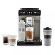 Taghareed De'Longhi Eletta Explore automatic coffee machine in silver, with a touch screen, milk carafe, and various coffee drinks displayed.