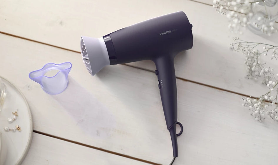 Taghareed Philips 3000 Series purple hair dryer with ThermoProtect attachment and 6 heat/speed settings.