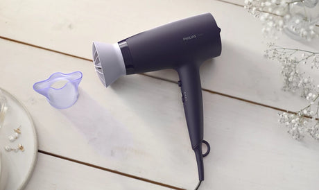 Taghareed Philips 3000 Series purple hair dryer with ThermoProtect attachment and 6 heat/speed settings.