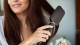 Taghareed StyleCare Essential Heated Straightening Brush with paddle head and purple bristles.