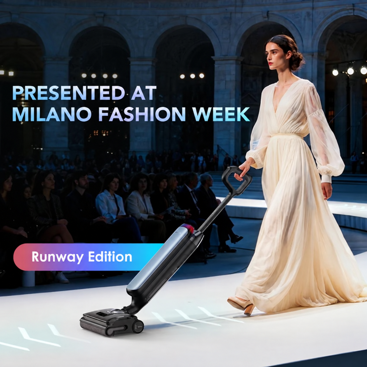 A woman in a flowing cream gown walks a fashion runway while pushing a sleek black and gray upright vacuum cleaner. Large text reads 'PRESENTED AT MILANO FASHION WEEK' and 'Runway Edition' over a dark arena with seated audience members in the background.