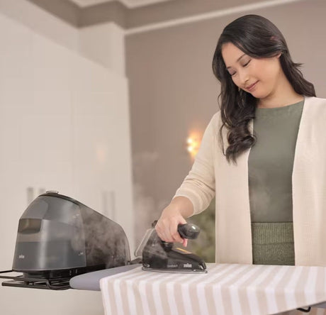 Braun CareStyle 5 Steam Generator Iron IS5249BK with 7.5 bar pressure and 2L water tank, used by a woman.