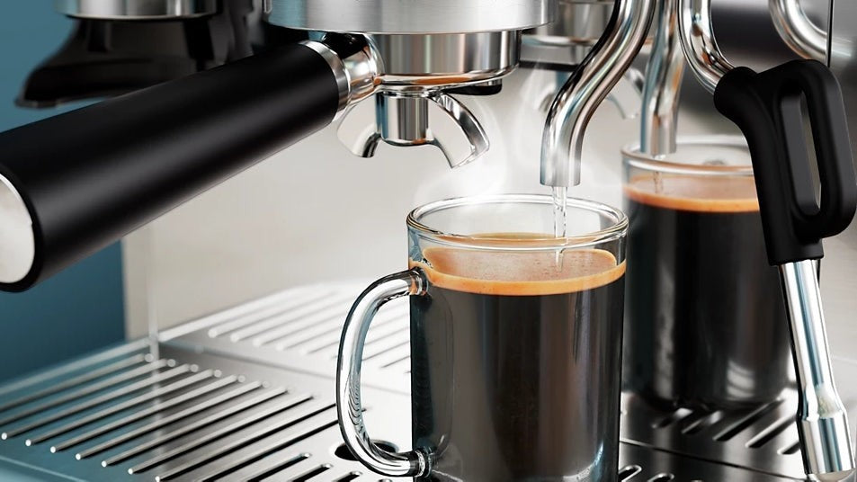 Taghareed Barista Brew semi-automatic espresso machine brewing espresso into a glass mug. Stainless steel.