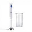Taghareed white Braun MultiQuick 1 hand blender with blue button and stainless steel shaft, next to a clear plastic beaker.
