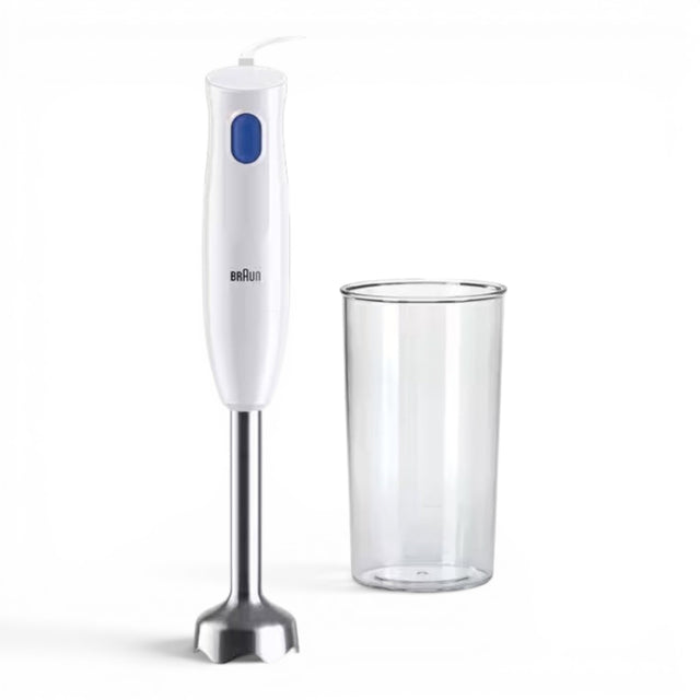 Taghareed white Braun MultiQuick 1 hand blender with blue button and stainless steel shaft, next to a clear plastic beaker.