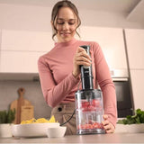 Taghareed Braun MultiQuick 5 Pro hand blender with chopper attachment, 1000W, 25 speed settings, chopping tomatoes.