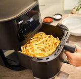 Taghareed Braun MultiFry 5 Air Fryer HF5030IBK with 6L capacity, 1700W, and 8 auto programs, cooking crispy fries.