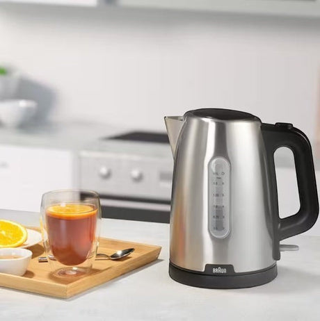 Taghareed Braun PurShine stainless steel electric kettle, 1.7L capacity, 2200W, with water level indicator and black handle.