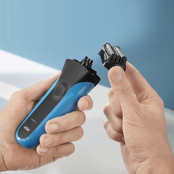Taghareed Braun Series 3 310s electric shaver in black and blue, showing the detachable foil head.