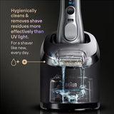 Taghareed Braun Series 9 Pro+ electric shaver in silver, shown cleaning in its SmartCare Center with liquid.