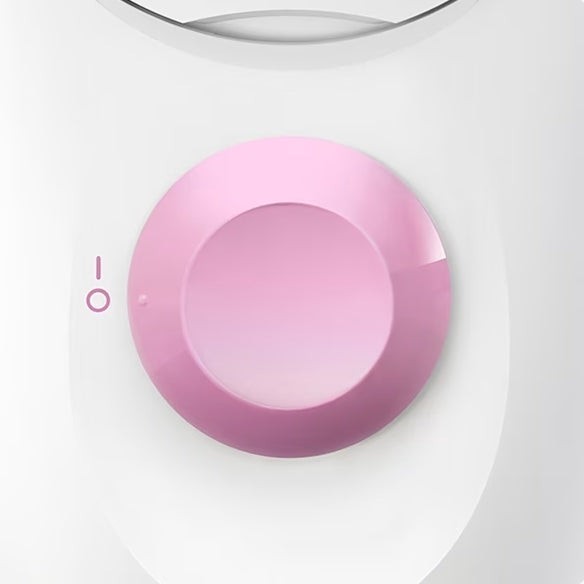 Taghareed Braun Silk-épil 1 epilator in white and pink with a pink control dial and on/off indicator.