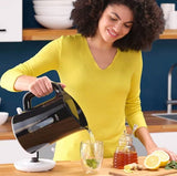Taghareed Braun Breakfast1 Water Kettle WK1100BK, 1.7L, 2200W, black, pouring hot water into a glass with mint.