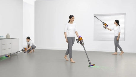 Taghareed cordless stick vacuum cleaner with multiple attachments, shown in use by a woman cleaning floors and high windows.