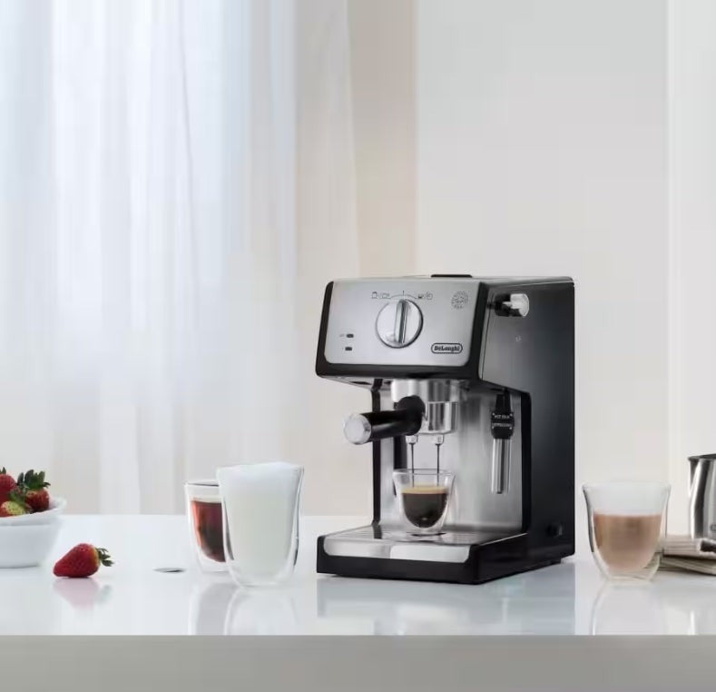 Taghareed De'Longhi ECP 35.31 espresso machine with stainless steel accents, brewing espresso into a glass.