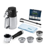 Taghareed De'Longhi La Specialista Maestro espresso machine accessories: milk frothing jug, portafilter, filter baskets, cleaning brush, and descaler.