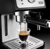 Taghareed De'Longhi ECP 35.31 espresso machine brewing coffee into a glass cup, black and stainless steel finish.