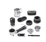 Taghareed De'Longhi La Specialista Touch EC9455.M barista kit with stainless steel milk pitcher, portafilter, tamper, and cleaning tools.