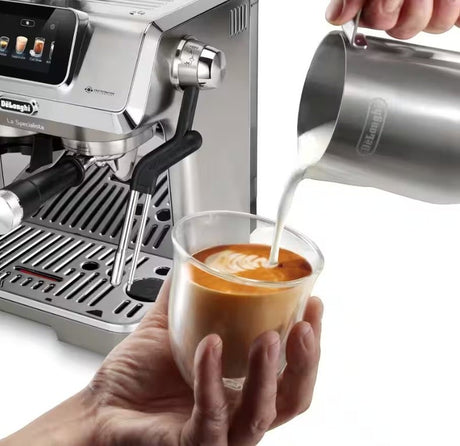 Taghareed De'Longhi La Specialista Touch espresso machine with stainless steel finish, making latte art in a glass.