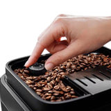 Taghareed De'Longhi Magnifica Evo coffee machine with adjustable grinder setting and coffee beans.