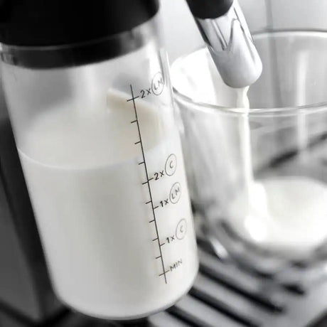 Taghareed De'Longhi Magnifica Evo automatic coffee machine milk carafe with measurement markings.