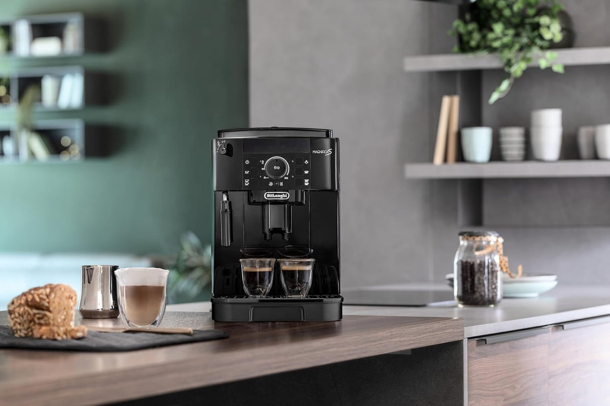 Taghareed De'Longhi Magnifica S compact black automatic coffee machine with built-in grinder and steam wand, brewing two espressos.