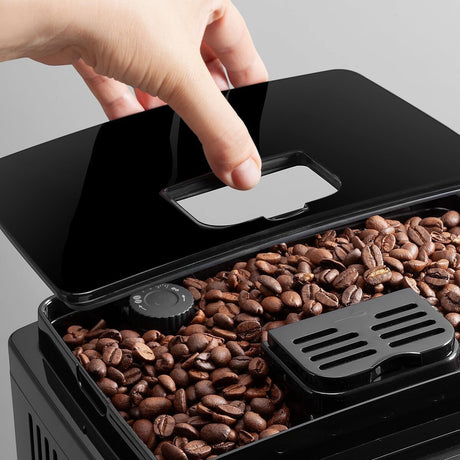 Taghareed De'Longhi Magnifica S coffee machine bean hopper with adjustable grind setting.