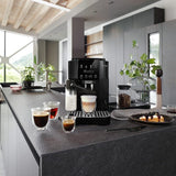 Taghareed De'Longhi Magnifica Start automatic coffee machine with LatteCrema Hot system, black, making a cappuccino.