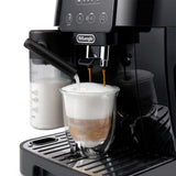 Taghareed De'Longhi Magnifica Start automatic coffee machine brewing a frothy cappuccino into a clear glass.