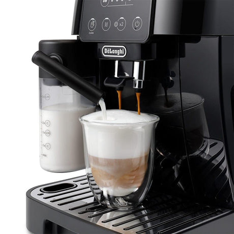 Taghareed De'Longhi Magnifica Start automatic coffee machine brewing a frothy cappuccino into a clear glass.