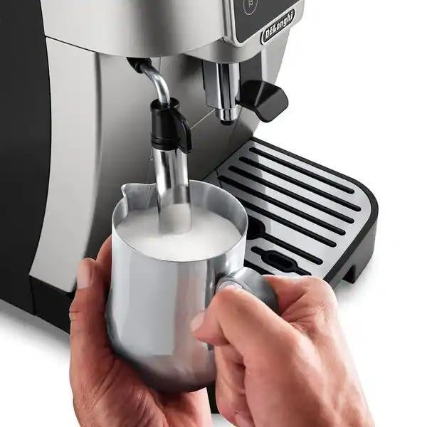 Taghareed De'Longhi Magnifica Start automatic coffee machine frothing milk in a stainless steel pitcher.