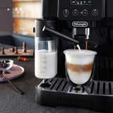 Taghareed De'Longhi Magnifica Start automatic coffee machine frothing milk into a glass for a latte.